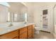 Bathroom with double vanity, shower, and door to backyard at 1358 E Jardin Dr, Casa Grande, AZ 85122