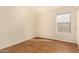 Bright bedroom with wood-look flooring and large window at 1358 E Jardin Dr, Casa Grande, AZ 85122