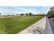 Paved pathway through grassy park area at 1358 E Jardin Dr, Casa Grande, AZ 85122