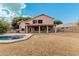 Two-story house with a swimming pool and covered patio in the backyard at 1503 N Quail Ln, Gilbert, AZ 85233