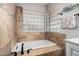 Bathroom with a built-in bathtub and neutral tile at 1503 N Quail Ln, Gilbert, AZ 85233