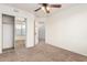 Spacious bedroom with mirrored closet and ceiling fan at 1503 N Quail Ln, Gilbert, AZ 85233