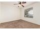 Well-lit bedroom featuring a ceiling fan and window at 1503 N Quail Ln, Gilbert, AZ 85233