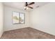 Bright bedroom with ceiling fan and mirrored closet at 1503 N Quail Ln, Gilbert, AZ 85233