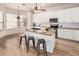 Modern kitchen with white cabinets, granite island, and stainless steel appliances at 1503 N Quail Ln, Gilbert, AZ 85233