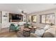 Living room with built-in shelving and a large TV at 1503 N Quail Ln, Gilbert, AZ 85233