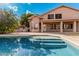 Inviting swimming pool with adjacent patio, steps, and a beautiful house at 1503 N Quail Ln, Gilbert, AZ 85233