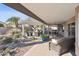 Landscaped backyard oasis with covered patio and pond at 15045 W Mulberry Dr, Goodyear, AZ 85395