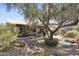 Landscaped backyard with covered patio and pond feature at 15045 W Mulberry Dr, Goodyear, AZ 85395