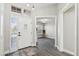 Bright entryway with white door and gray wood-look floors at 15045 W Mulberry Dr, Goodyear, AZ 85395