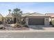 Single-story home with a dark brown garage door and landscaped front yard at 15045 W Mulberry Dr, Goodyear, AZ 85395