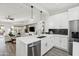 Modern kitchen with white cabinets, stainless steel appliances, and large island at 15045 W Mulberry Dr, Goodyear, AZ 85395