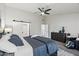 Main bedroom with king-size bed, sliding barn doors to the bathroom, and a relaxing chair at 15045 W Mulberry Dr, Goodyear, AZ 85395