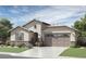 Single-story home with a two-car garage and stone accents at 1505 W J Waltz Way, Apache Junction, AZ 85120