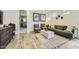 Comfortable living room with green sofa, wooden coffee table, and an adjacent hallway at 1505 W J Waltz Way, Apache Junction, AZ 85120