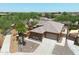 Aerial view of single-story house with desert landscaping, driveway, and two-car garage at 15338 W Montecito Ave, Goodyear, AZ 85395