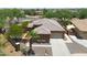 An aerial view of a house, showcasing its exterior, driveway, landscaping, and surrounding neighborhood at 15338 W Montecito Ave, Goodyear, AZ 85395