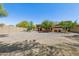 Large backyard with gravel and mature trees, offering ample space at 15338 W Montecito Ave, Goodyear, AZ 85395