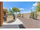 Landscaped backyard with a built-in grill and a gravel patio at 15338 W Montecito Ave, Goodyear, AZ 85395