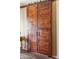 Double sliding barn doors add rustic charm at 15338 W Montecito Ave, Goodyear, AZ 85395