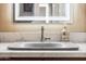 Vanity with single sink and modern faucet, illuminated mirror at 15338 W Montecito Ave, Goodyear, AZ 85395