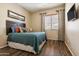 Spacious bedroom with wood floors and rustic wood headboard at 15338 W Montecito Ave, Goodyear, AZ 85395