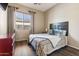 Guest bedroom with wood floors and a red dresser at 15338 W Montecito Ave, Goodyear, AZ 85395