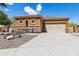 Single story home with stucco and stone exterior, two car garage, and desert landscaping at 15338 W Montecito Ave, Goodyear, AZ 85395