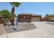 Single-story home with stucco and stone exterior, two-car garage, and desert landscaping at 15338 W Montecito Ave, Goodyear, AZ 85395