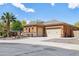 Single-story home with stucco exterior, two-car garage, and desert landscaping at 15338 W Montecito Ave, Goodyear, AZ 85395