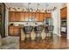 Island kitchen with wood cabinets and a breakfast bar at 15338 W Montecito Ave, Goodyear, AZ 85395