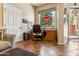 Home office features wood desk, stained glass window and tile floor at 15338 W Montecito Ave, Goodyear, AZ 85395