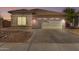 Single-story home with attached garage and landscaped front yard at 15548 N 156Th Ln, Surprise, AZ 85374