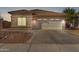 Single-story home with a two-car garage and desert landscaping at 15548 N 156Th Ln, Surprise, AZ 85374