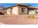 Side view of a charming one-story house with stone accents at 15548 N 156Th Ln, Surprise, AZ 85374