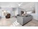 Spacious living room with gray sectional sofa and tile floors at 15548 N 156Th Ln, Surprise, AZ 85374