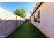 Landscaped side yard with grassy area and wall at 15548 N 156Th Ln, Surprise, AZ 85374