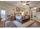 Main bedroom with a king-size bed, wood floors, and private access to a balcony at 16005 S 10Th Pl, Phoenix, AZ 85048