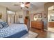 Main bedroom with king bed, dresser, and bathroom access at 16005 S 10Th Pl, Phoenix, AZ 85048