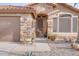 Front entry of home with stone facade, security door, and desert landscaping at 16005 S 10Th Pl, Phoenix, AZ 85048