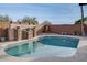 Inviting swimming pool with a stone water feature and fire pit at 16005 S 10Th Pl, Phoenix, AZ 85048