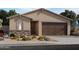 One-story house with brown garage door and stone accents at 17466 W Eva St, Waddell, AZ 85355