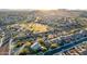 Panoramic aerial view of a residential neighborhood featuring well-maintained homes and community green spaces at 17833 W Verdin Rd, Goodyear, AZ 85338