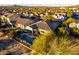 Aerial view of a home featuring a pool, patio, lush landscaping and views of neighborhood at 17833 W Verdin Rd, Goodyear, AZ 85338