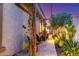 Inviting back yard featuring lush greenery, stone pavers, and a trellis, creating a serene outdoor retreat at 17833 W Verdin Rd, Goodyear, AZ 85338