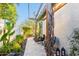 Inviting back yard featuring lush greenery, stone pavers, and a trellis, creating a serene outdoor retreat at 17833 W Verdin Rd, Goodyear, AZ 85338