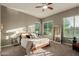 Sunlit bedroom with a large window, wooden bed frame, and serene decor at 17833 W Verdin Rd, Goodyear, AZ 85338