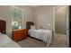 Bedroom with single bed, wicker headboard, and neutral colors, next to the window at 17833 W Verdin Rd, Goodyear, AZ 85338