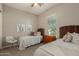 Bedroom with twin beds, wicker headboards, and neutral colors, perfect for children at 17833 W Verdin Rd, Goodyear, AZ 85338