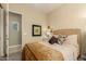 Bright bedroom featuring woven headboard, decorative pillows, and an inviting, cozy aesthetic at 17833 W Verdin Rd, Goodyear, AZ 85338